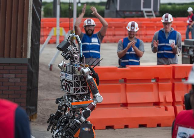 Members of team Valor cheer as ESCHER completes the first challenge during day two of the DARPA Robotics Challenge at California June 6 2015 Courtesy of the Office of Naval Research