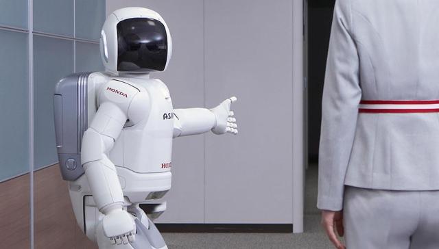 Hondas ASIMO gives directions Courtesy of Honda Global