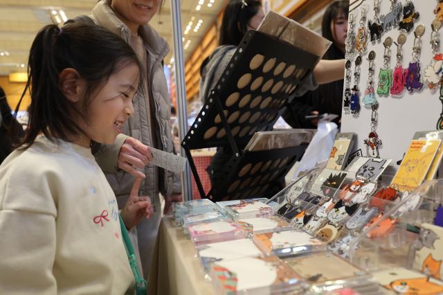 A kid views a booth at K-illustration Fair Seoul 2026 at COEX in Gangnam Seoul Jan 30 2026 AJP Han Jun-gu