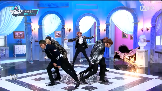This photo captured from Mnet K-pop youtube channel show members of BTS performing their title track Blood Sweat  Tears for the first time Photo captured from Mnet K-pop youtube channel
