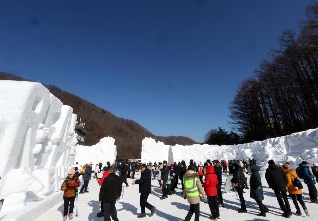 Visitors look around large snow sculptures at the Taebaeksan Snow Festival at the Danggol Plaza area of Taebaeksan National Park in Taebaek Gangwon Province on Feb 1 2026 Yonhap
