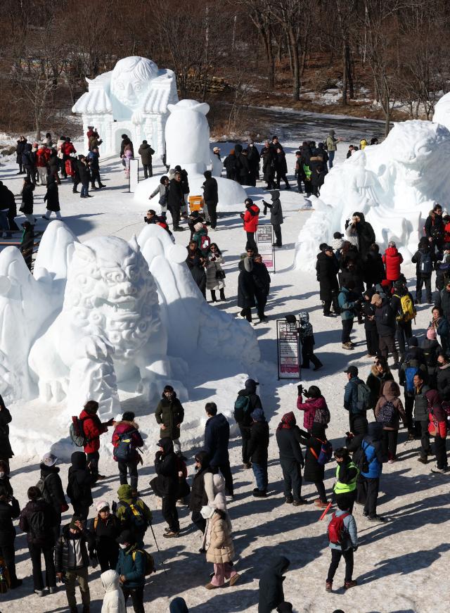 Visitors look around large snow sculptures at the Taebaeksan Snow Festival at the Danggol Plaza area of Taebaeksan National Park in Taebaek Gangwon Province on Feb 1 2026 Yonhap