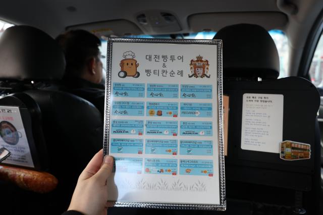 This photo taken within An Seong-woo's taxi show partial list of bakeries  stationed within the ride for visitors to select from . Feb.3.2026 Photo by Han Jung-gu