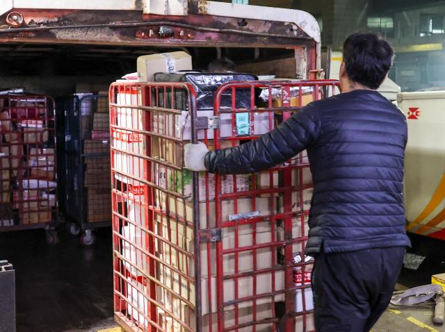 Workers sort parcel boxes at the Dongseoul Mail Logistics Center in Seoul’s Gwangjin Ward ahead of the Lunar New Year holiday on Feb 11 2026 AJP Yoo Na-hyun