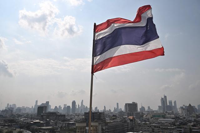 The Thai flag is seen with the city skyline the day after the general election, in Bangkok on Feb. 9, 2026. AFP-Yonhap