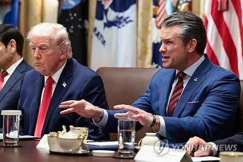 This undated file photo shows US Secretary of Defense Pete Hegseth right speaking during a Cabinet meeting as President Donald Trump looks on in Washington DC Reuters-Yonhap