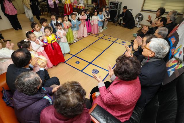 Children from a daycare center dressed in traditional hanbok perform sebae and sing children’s songs at a senior center in Songpa-gu Seoul on Feb 11 2026 Yonhap