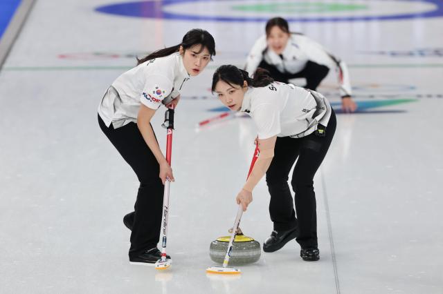 South Koreas Seol Ye-eun and Kim Su-ji sweep during the 10th end against Japan in womens curling round-robin action Yonhap