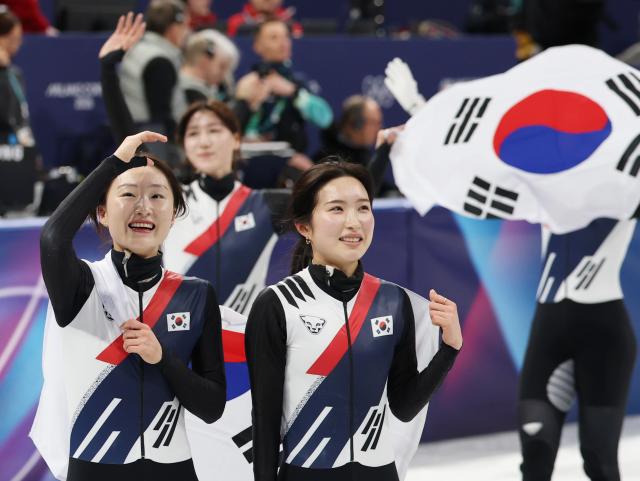 South Korea’s Choi Min-jeong, Kim Gil-li and teammates celebrate after winning gold in the women’s 3,000-meter short track relay final at the Milan Ice Skating Arena in Milan, Italy, on Feb. 18, 2026.