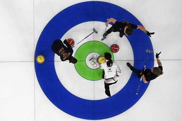 South Koreas Gim Eunji Swedens Anna Hasselborg Swedens Agnes Knochenhauer and Swedens Johanna Heldin compete in the curling womens round robin between Sweden and South Korea during the Milano Cortina 2026 Winter Olympic Games at the Cortina Curling Olympic Stadium in Cortina dAmpezzo on February 18 2026 AFPYonhap