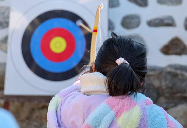A child shoots an arrow during a traditional archery experience at the “2026 Namsangol Seollal Festival” at Namsangol Hanok Village in Jung District Seoul on Feb 17 2026 AJP Yoo Na hyun