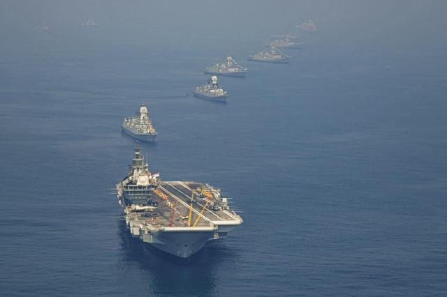 An aerial view shows the aircraft carrier INS Vikrant leading a formation of Indian Navy ships during IFR 2026 in Visakhapatnam on Feb 18 Courtesy of the Ministry of Defence Government of India