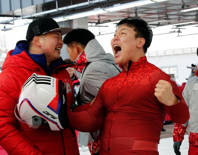 Driver Won Yunjong of South Korea celebrates tying for the silver medal during the four-man bobsled competition final at the 2018 Winter Olympics in Pyeongchang South Korea Sunday Feb 25 2018APYonhap