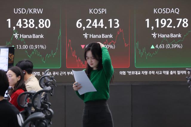 The KRWUSD exchange rate KOSPI and KOSDAQ indexes are displayed on a screen at the Hana Bank dealing room in Seoul on Friday Feb 27 Yonhap