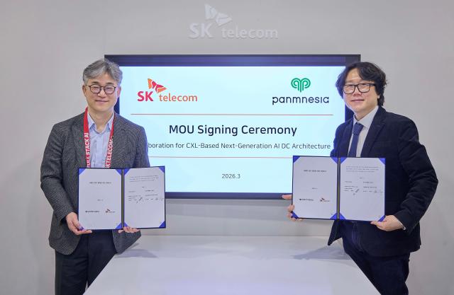 Chung Seok-geun left Head of SKTs AI CIC and Panmnesia CEO Jeong Myung-soo sign an MOU to jointly develop a CXL-based next-generation AI data center architecture at the SKT meeting room during MWC 2026 in Barcelona Spain Courtesy of SKT