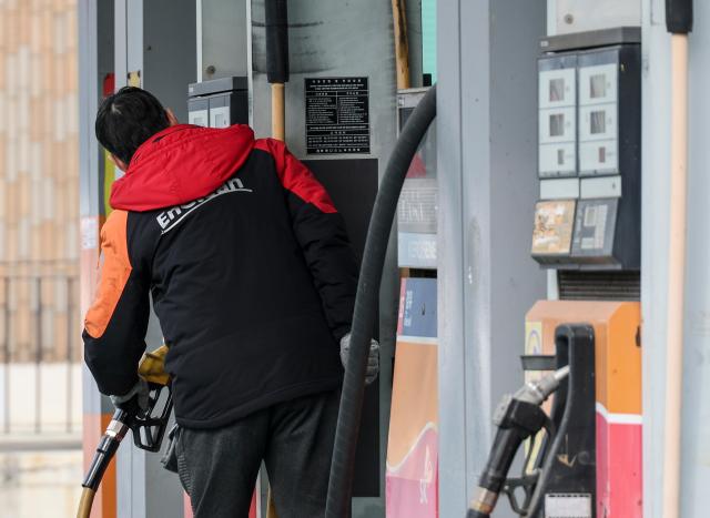 An employee checks a fuel pump at a gas station in Seoul on March 5 2026 AJP Yoo Na-hyun