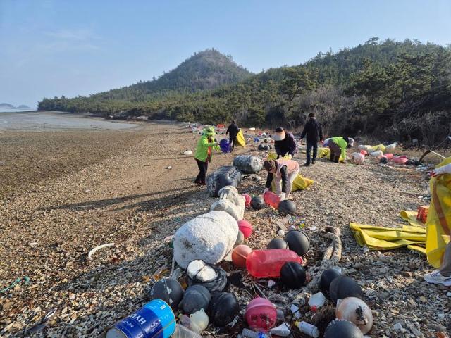 지난 5일 신의면 해안가 일원에서 지역사회단체와 신의면 직원들이 해양폐기물 수거 작업을 하고 있다사진신안군
