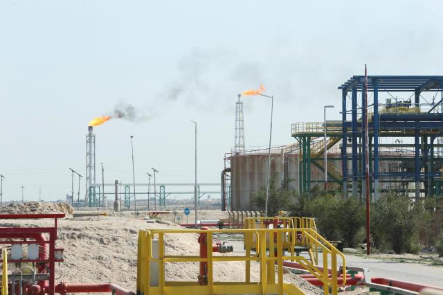 Flames rise from a gas flare at the Rumaila oil field as the country cuts nearly 15 million barrels per day of output amid halted exports following the closure of the Strait of Hormuz in Basra Iraq March 4 2026 REUTERSYonhap