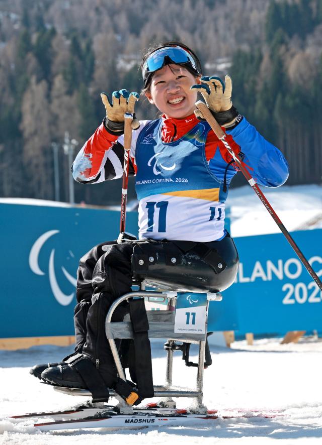 Kim Yoon-ji of South Korea celebrates after winning gold in the women’s sitting biathlon sprint 125 km final at the 2026 Milan-Cortina Winter Paralympics in Tesero Italy March 8 2026 local time Yonhap 20260308