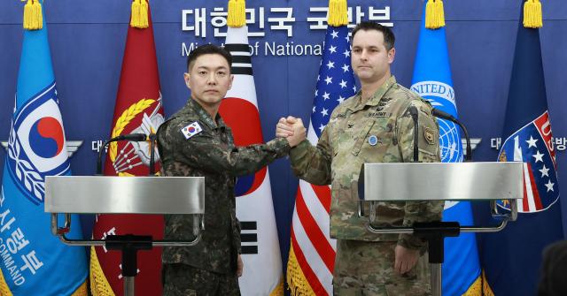 Jang Do-young public affairs director of South Korea’s Joint Chiefs of Staff and Ryan Donald public affairs director of the United Nations Command Combined Forces Command and United States Forces Korea shake hands after announcing the plan for the 2026 Freedom Shield exercise at the Defense Ministry in Yongsan-gu Seoul on Feb 25 2026 Yonhap 