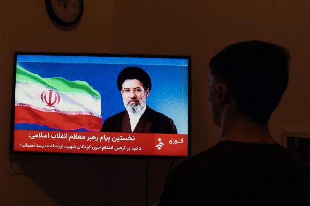 A man watches a televised statement by Irans new supreme leader Mojtaba Khamenei on March 12 2026 Irans new supreme leader ordered the vital Strait of Hormuz oil shipping lane to remain closed on March 12 while US President Donald Trump said stopping the Islamic republics evil empire was more important than crude prices Ayatollah Mojtaba Khamenei who was reportedly injured in an air strike has yet to appear publicly since his nomination as supreme leader and his defiant message was read by a newscaster on state television AFP-Yonhap 