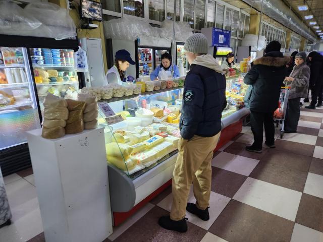 Shoppers buy dairy products at the Artyom Market in the old quarter of Astana on March 12 AJP Park Sae-jin