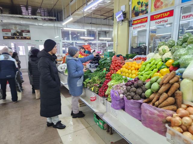 A female shopper examines fresh vegetables at the Artyom Market in the old quarter of Astana on March 12 AJP Park Sae-jin