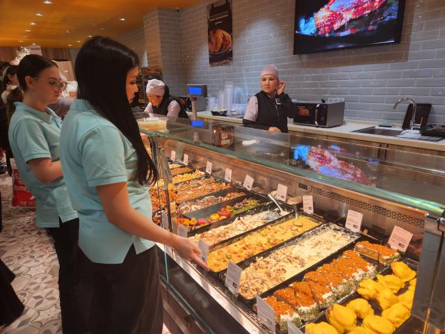Shoppers examine various food menus and desserts at Galmart located inside the Mega Silk Way mall in Astanas new district on March 15 AJP Park Sae-jin