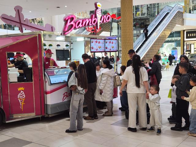 People stand in a long line to buy ice cream from a stall located inside the Mega Silk Way mall in Astanas new district on March 15 AJP Park Sae-jin