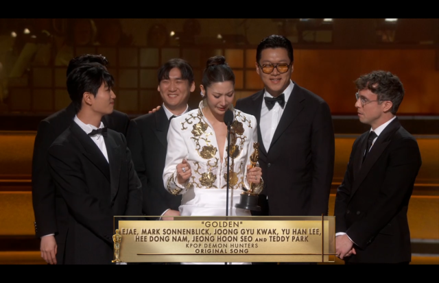 This photo captured during the live event of 98th Oscar show EJAE and producers receiving and giving out an acceptance speech for the highly anticipated Best Original Song“ award