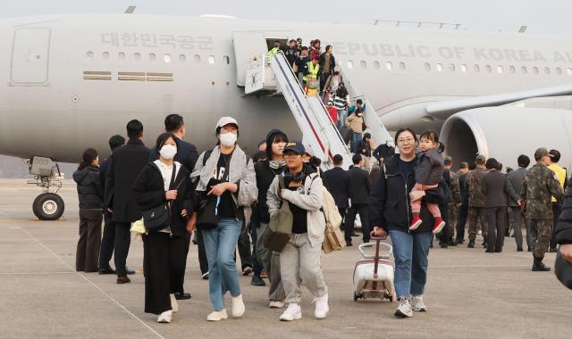 Korean residents returning from the Middle East on a military multipurpose transport aircraft due to worsening conditions in the region walk at Seoul Airport in Seongnam Gyeonggi Province on the afternoon of March 15 2026 Yonhap