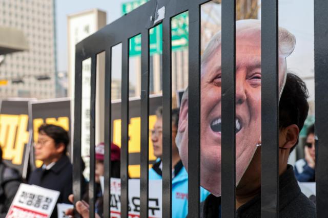 An emergency press conference by Seoul civic groups opposing a possible deployment to the Strait of Hormuz and war is held in front of the KT building in Gwanghwamun central Seoul March 17 2026 AJP Yoo Na-hyun