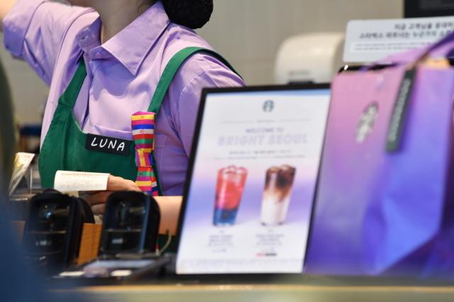 Photo shows Starbucks Worker with Korean traditional decorative piece on her apron  AJP Joonha Yoo March 18 2026