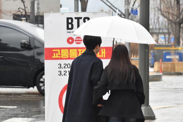 Pedestrians are checking out the road blockage sign as BTS concert is expected to take place in March 21 AJP Joonha Yoo