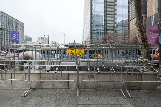 Expandable police barricades have been installed along sidewalks and key intersections forming designated walking corridors and limiting cross-flow between streets AJP Han Jung-gu 