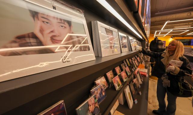 Tourists browse BTS merchandise at a K-pop goods shop in Myeongdong Jung District Seoul March 18 2026 AJP Yoo Na-hyun 20260318