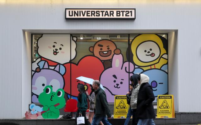 Tourists pass by a shop selling BTS K-pop merchandise in Myeongdong Jung District Seoul March 18 2026 AJP Yoo Na-hyun 20260318
