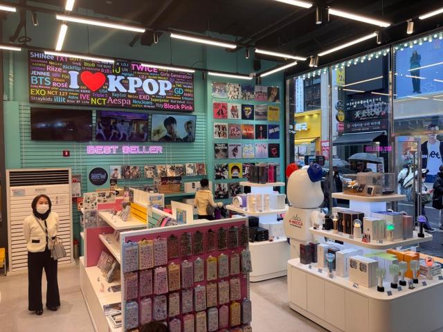 A K-pop merchandise shop in Myeongdong Seoul displaying albums light sticks and character goods on March 18 2026 AJP Ryu Yuna