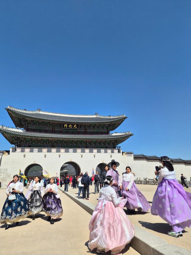Travelers are taking photos and enjoying the view of Korean traditional monument dressed in purple Hanbok as BTS anticipated return is closing in  March 19 2026 AJP 