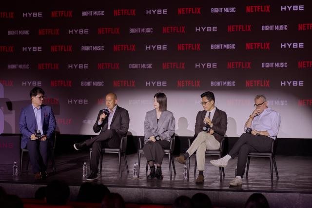 This photo provided by Netflix show From left Brandon Riegg Vice President of Nonfiction Series and Sports at Netflix Kim Hyun-jung Vice President at BigHit Music Yoo Dong-joo President of HYBE Music Group APAC and Garrett English Executive Producer during media briefing for BTS upcoming live concert event 