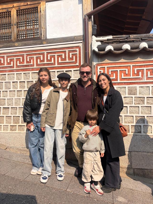 A family from Los Angeles poses in Bukchon Hanok Village Seoul ahead of the BTS concert on March 20 2026 AJP Ryu Yuna