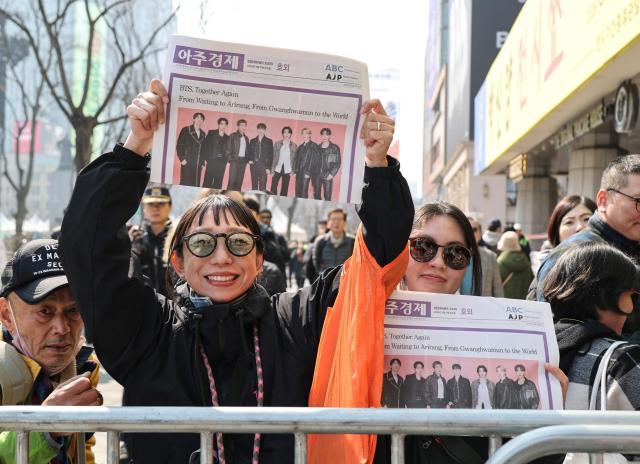 A fan holds up AJPs BTS special edition handed out around Gwanghwamun on March 21 2026 AJP Yoo Na-hyun