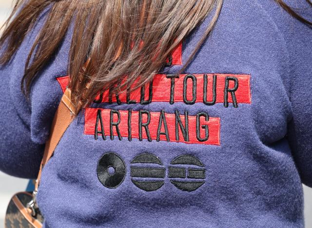 A fan wears a BTS sweater to brace the chilly winds in Gwanghwamun Square in central Seoul on March 21 AJP Yoo Na-hyun