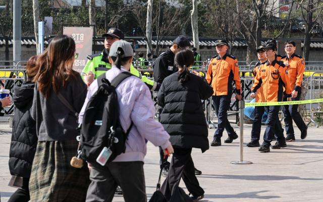 Police officers and firefighters patrol Seoul Plaza ahead of the BTS concert at Gwanghwamun Square in Seoul on March 21 2026 AJP Yoo Na-hyun 20260321