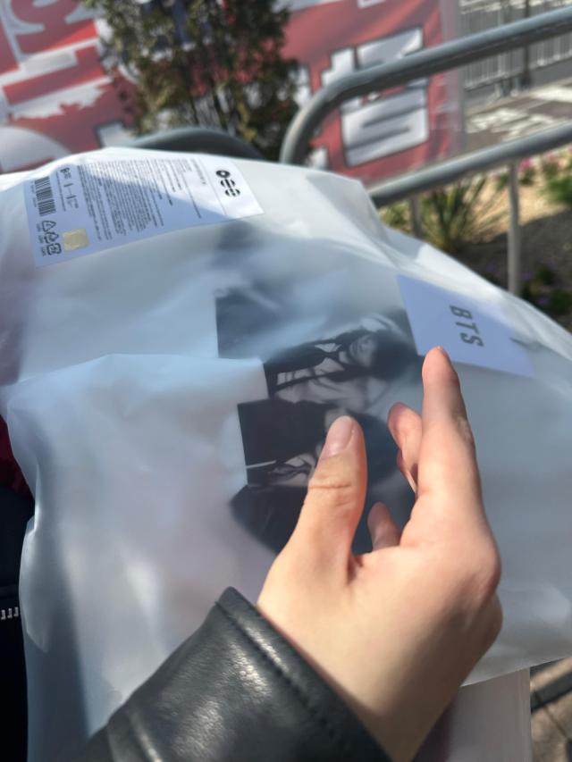 Lana Ro 25 Russia shows a BTS apparel is seen packaged after purchase at a pickup booth in Seoul on March 21 2026 AJP Kim Hee-su