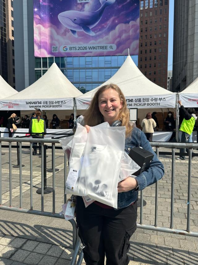 Adrniana 25 from America poses for a photo near the BTS MD Booth in Gwanghwamun Seoul on March 21 2026 AJP Kim Hee-su