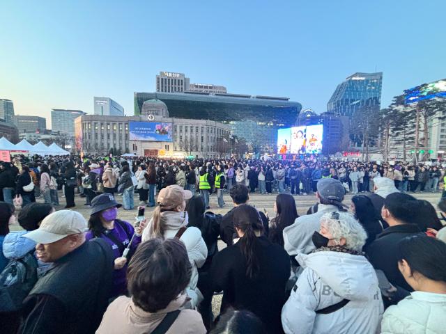 Fans find themselves at City Hall after nearly an hours move at a snails pace through police escort about an hour before the 8 pm concert at Gwanghwamun on March 21 2026 Han Jun-gu