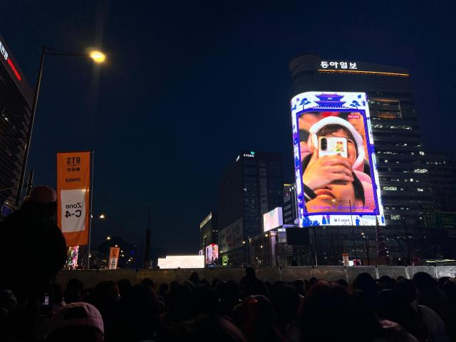 Giant screens showed fans across Gwanghwamun to entertain those kept inside the perimeter 3 hours before the concert started at 8 pm on March 21 2026 Joonha Yoo
