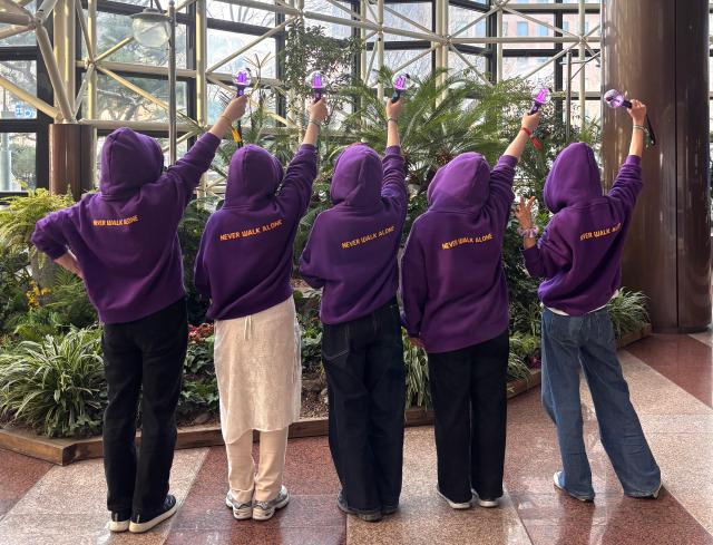 ARMYs pose holding ARMY Bombs BTSs official light stick while waiting for the concert at Gwanghwamun Plaza in Seoul March 21 2026 AJP Ryu Yuna
