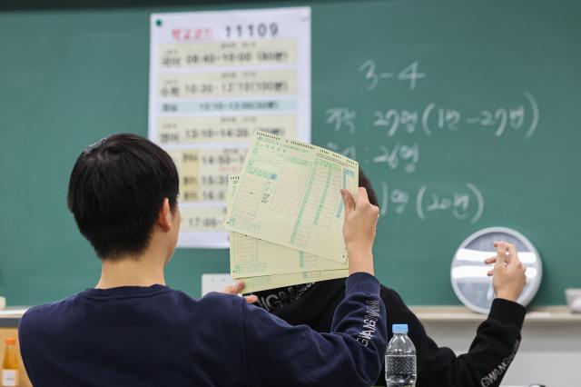 Students receive OMR answer sheets during the nationwide March mock exam at Gwangnam High School in Seoul’s Gwangjin District March 24 2026 Yonhap 20260324